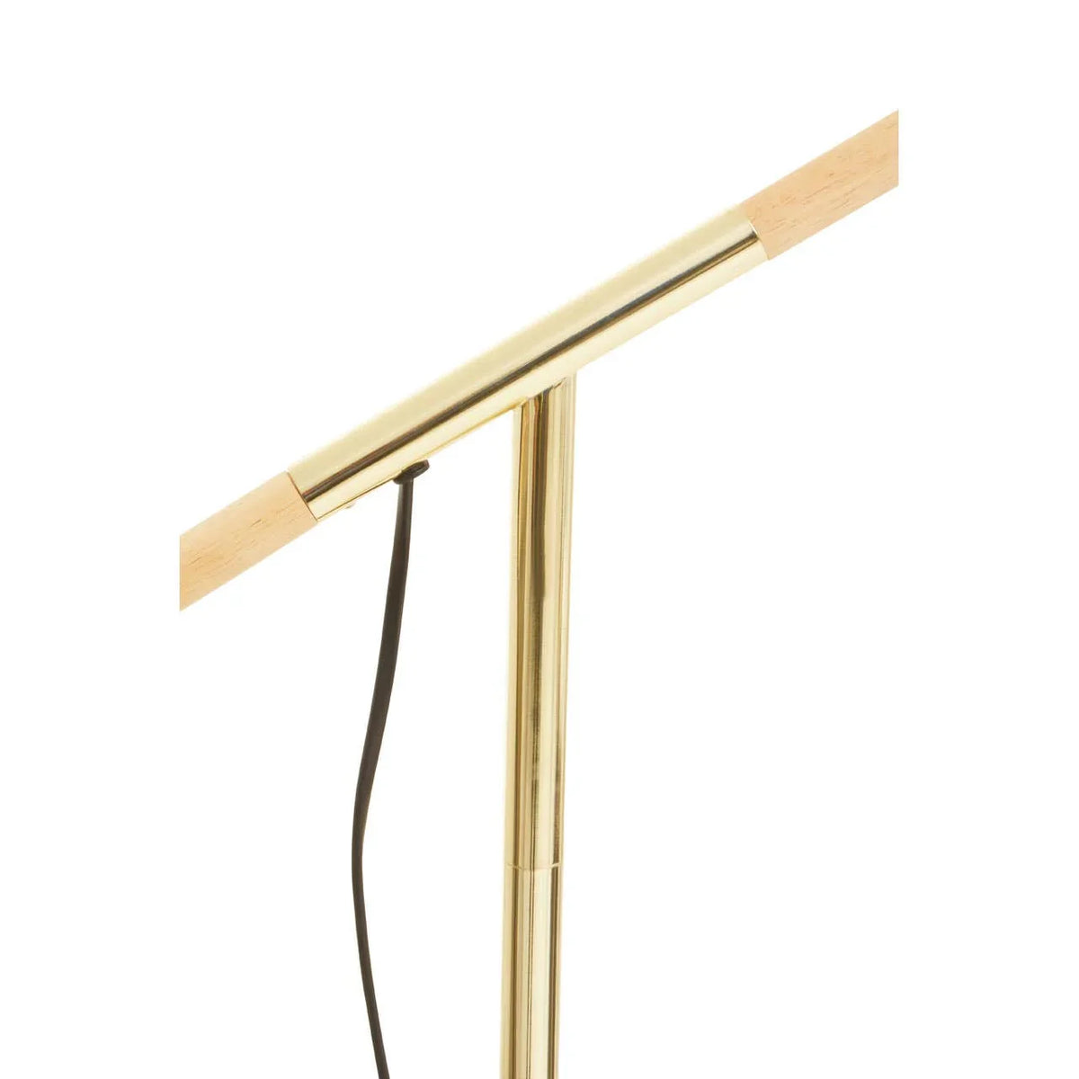 Gold and wood floor lamp stem with black power cord, close-up view