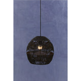 Black woven rattan pendant light with exposed bulb against blue textured wall