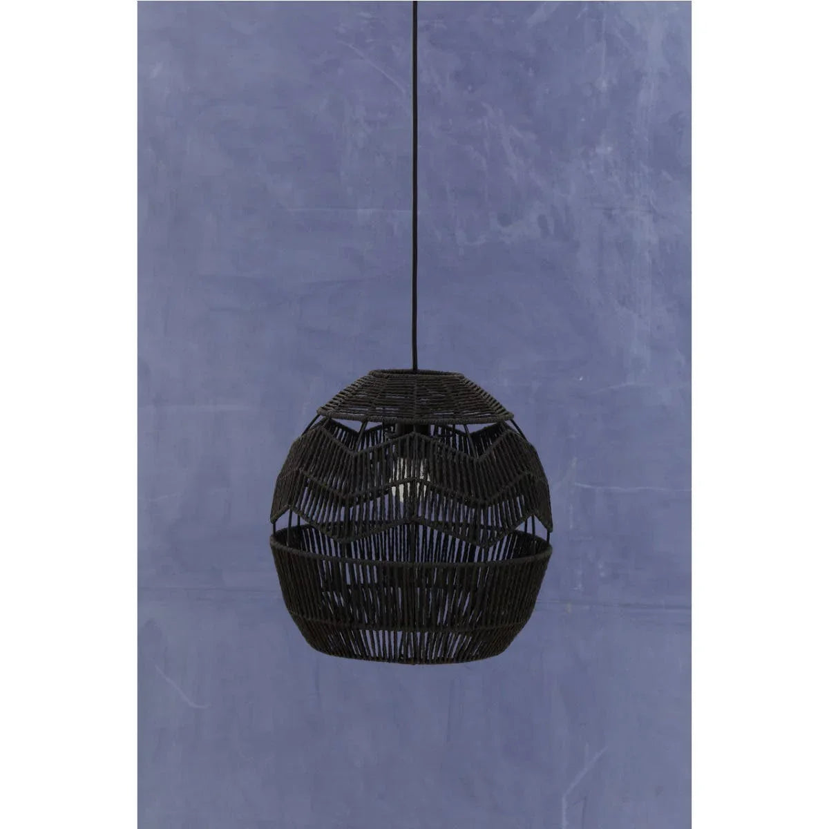Black rattan pendant light with woven pattern against a blue wall