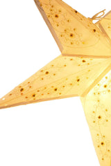 Cream paper star lantern with cutout patterns and yellow floral embellishments, illuminated