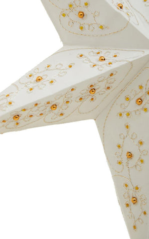 White paper star lantern with gold beaded floral decoration, close-up view of one point