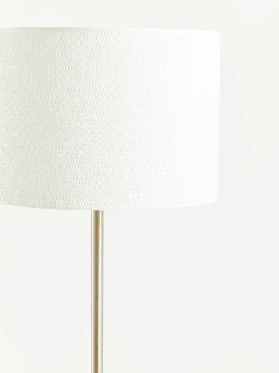 White fabric floor lamp with textured drum shade and slim metal stand