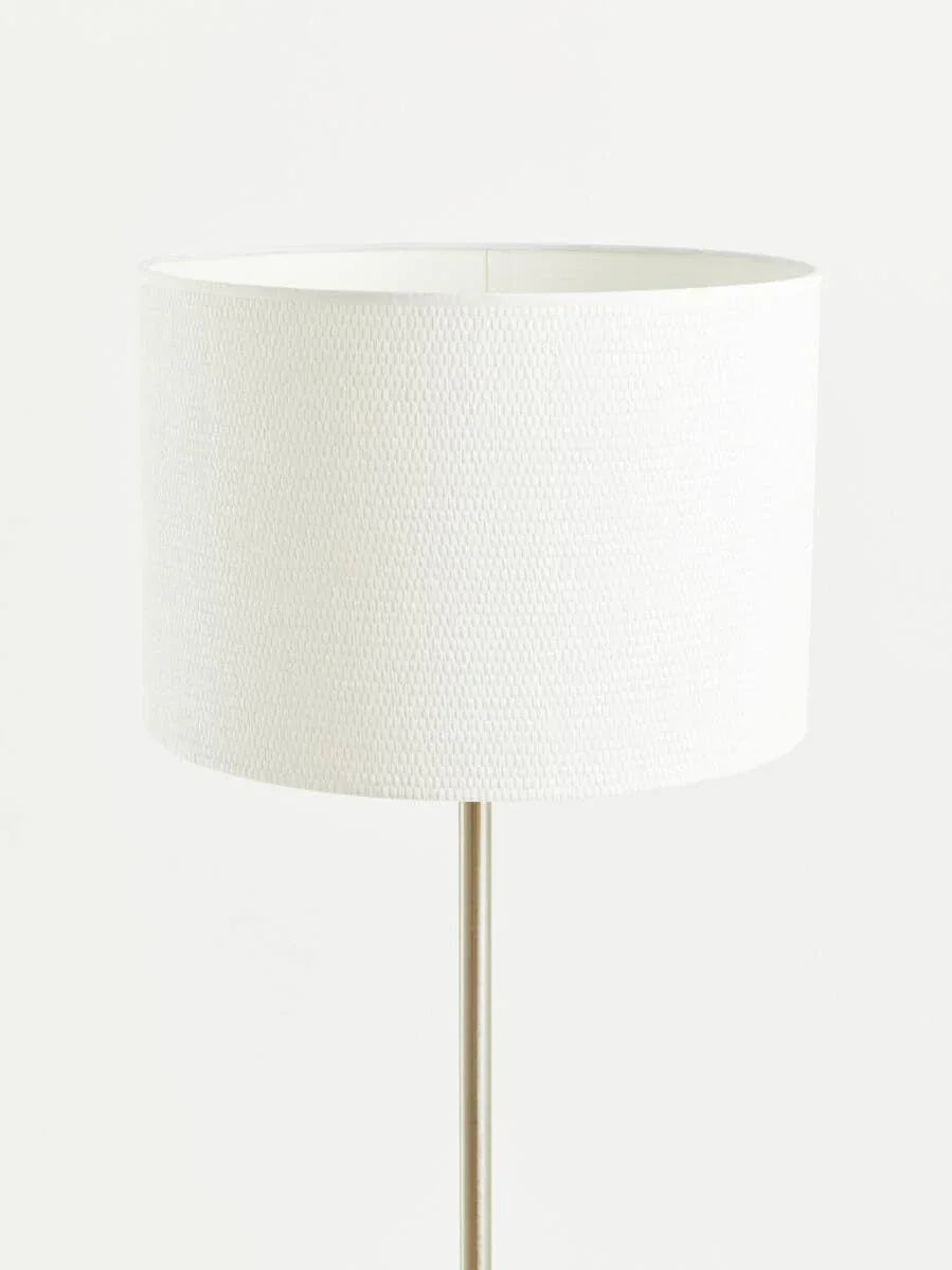 White fabric floor lamp with cylindrical shade and slim metallic base
