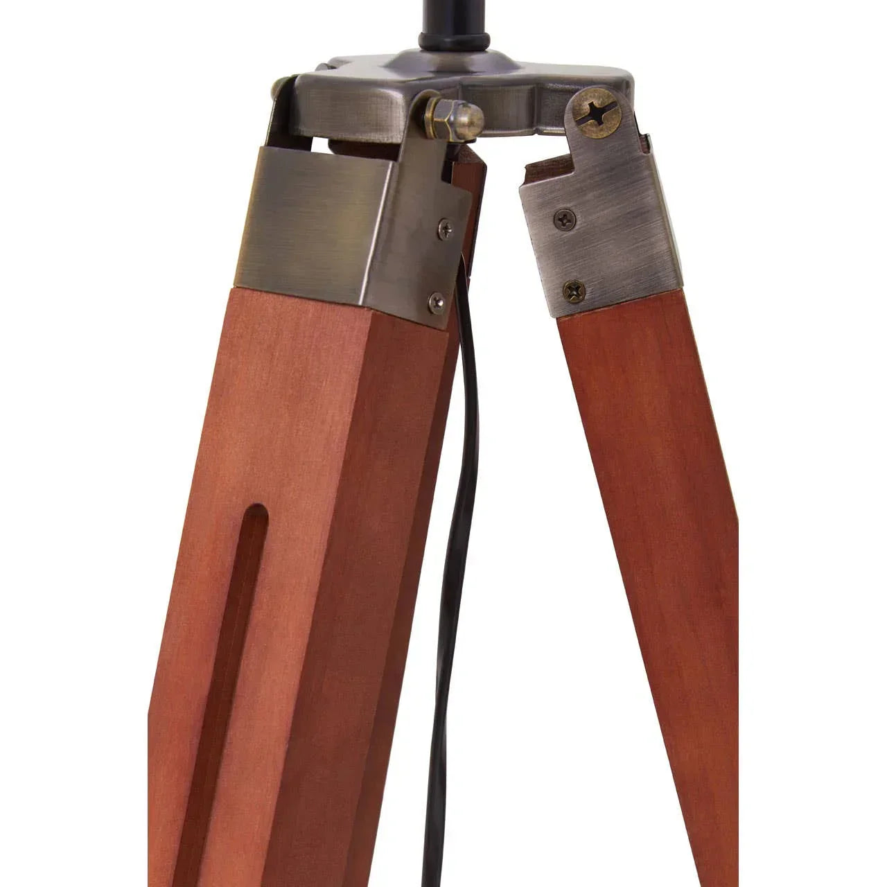 Close view of wooden tripod lamp legs with metal fittings and visible power cable