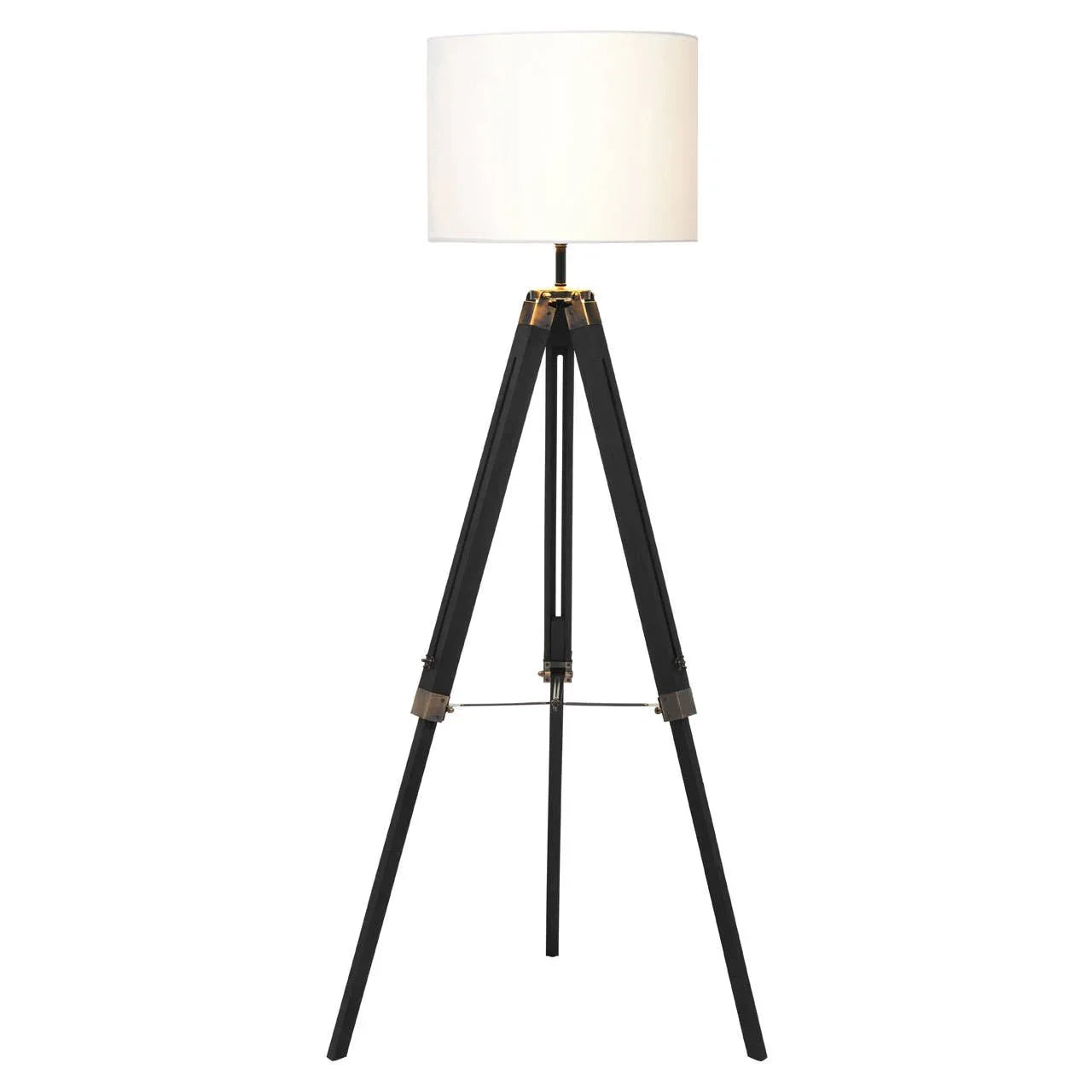 Black tripod floor lamp with white drum shade and gold metal accents