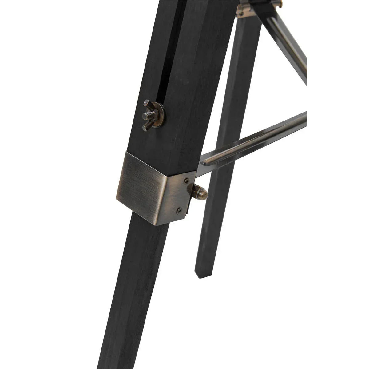 Close-up of black wooden furniture leg with brass hardware and metal support bar