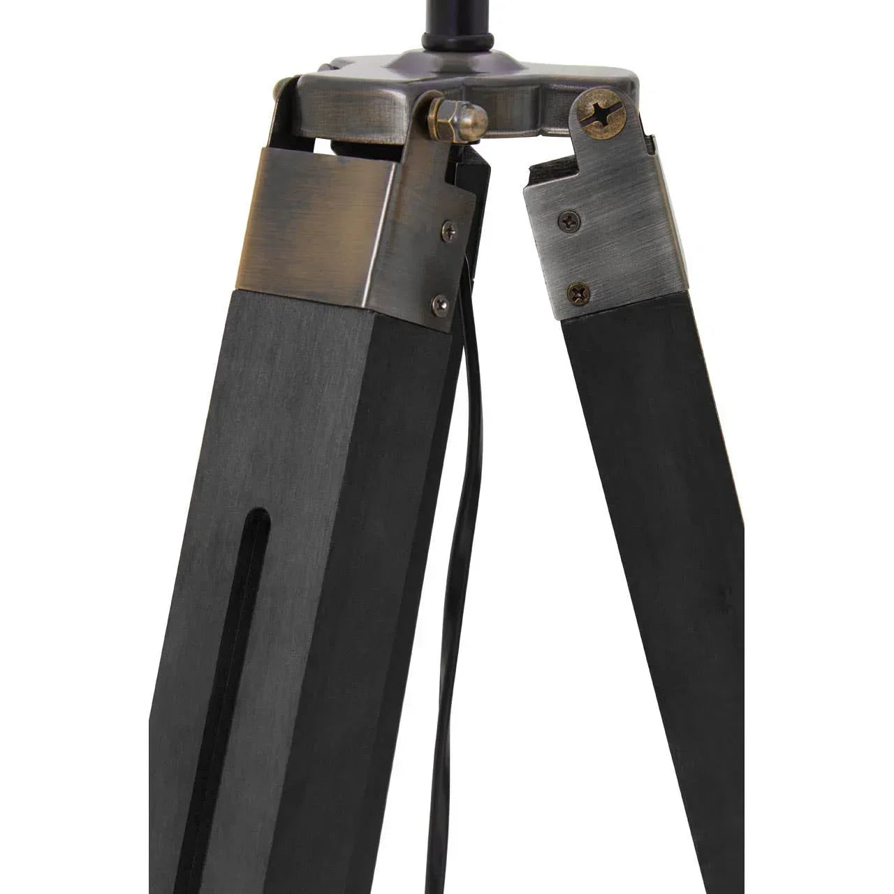 Black wooden tripod lamp base with metal joints and visible power cord close-up