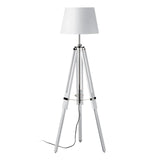 White tripod floor lamp with fabric shade and exposed cord on plain background