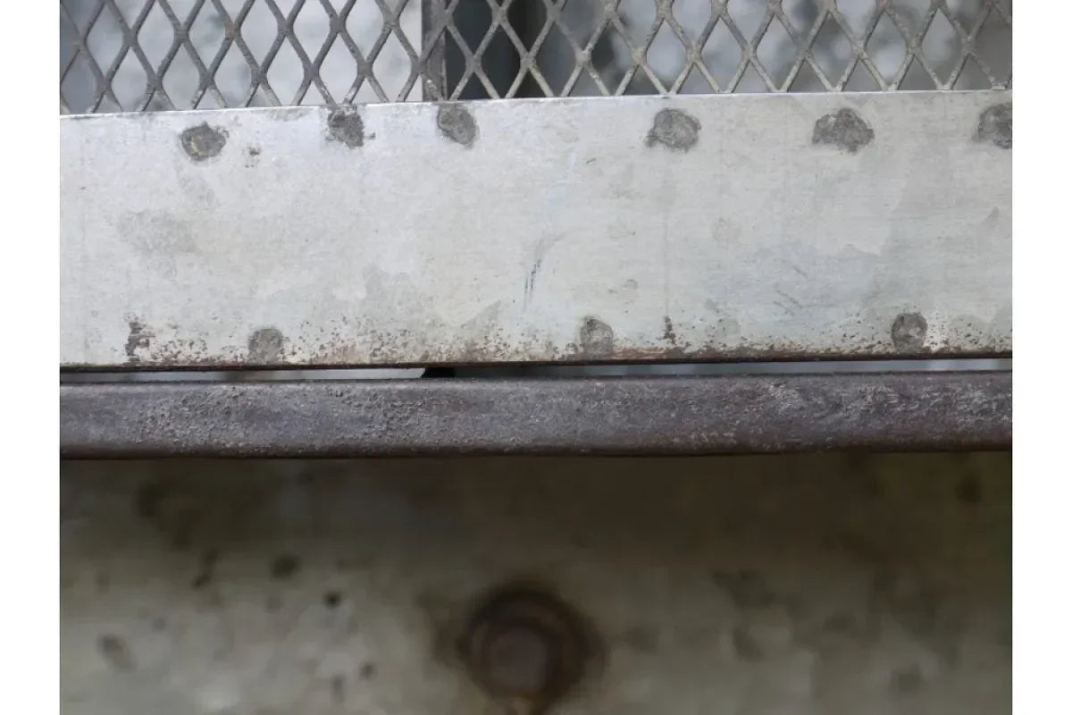 Closeup of metal furniture frame with lattice detailing and visible welds