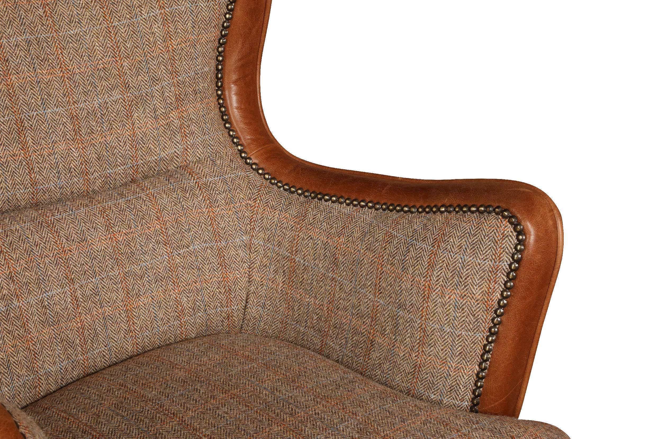Brown tweed fabric armchair with tan leather trim and brass stud detailing