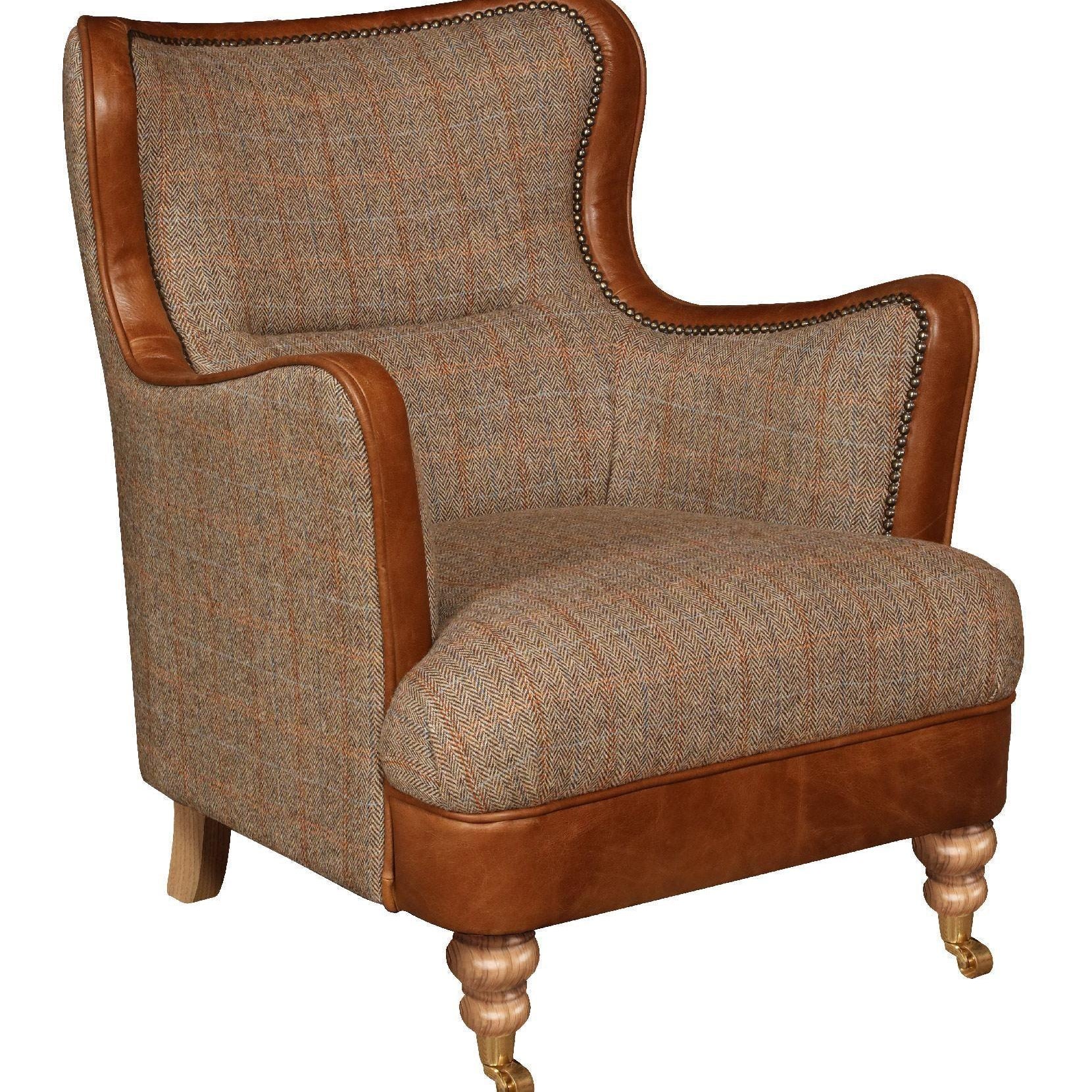 Herringbone fabric armchair with brown leather trim and wooden legs, front angled view