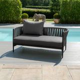 Grey outdoor sofa with rope detailing and cushion on poolside patio