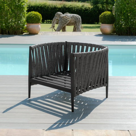 Charcoal rope outdoor armchair with open back on decking beside swimming pool