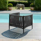 Charcoal outdoor lounge chair with woven rope design on decking beside swimming pool
