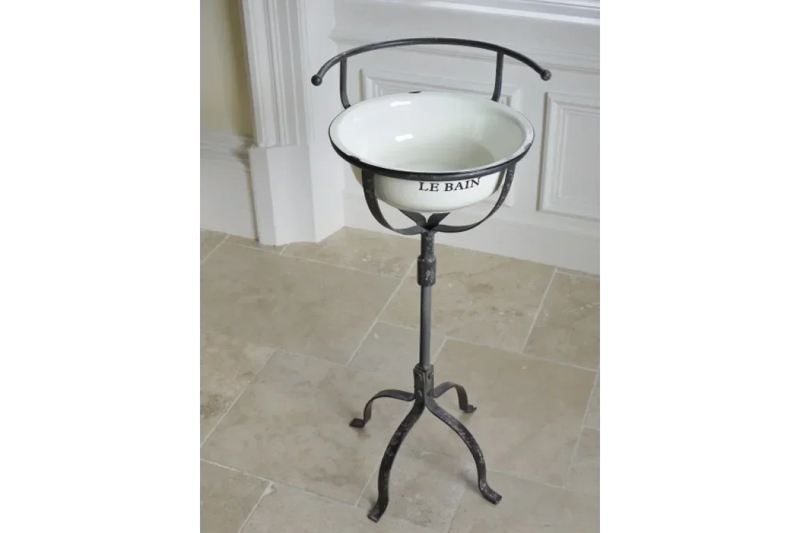 Freestanding vintage wash stand with enamel bowl and metal tripod base for bathroom decor