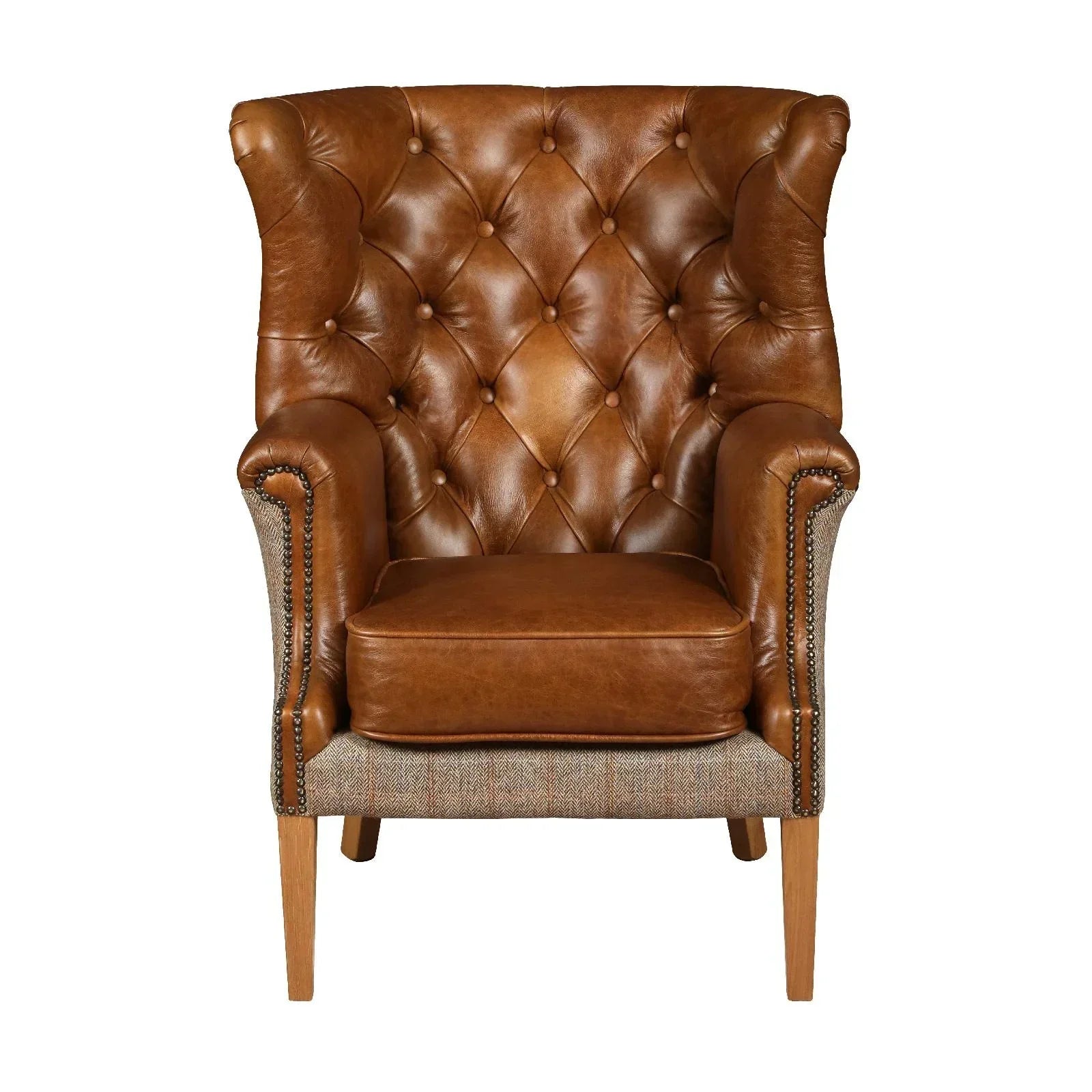 Brown leather armchair with tufted backrest, wooden legs, and studded detailing