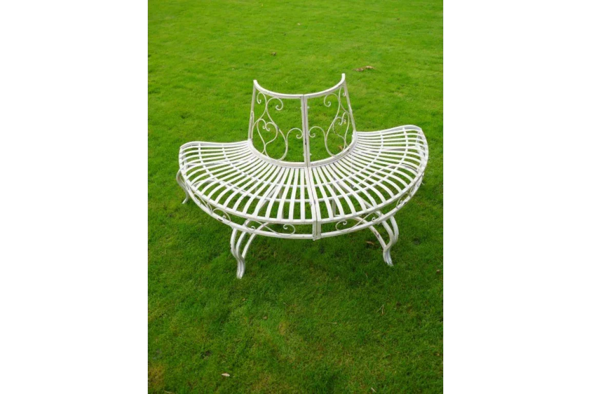 White metal tree bench with curved backrest on green lawn