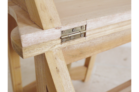 Close-up of unfinished light wood chair step detail showing metal hinge and natural wood grain angle view.