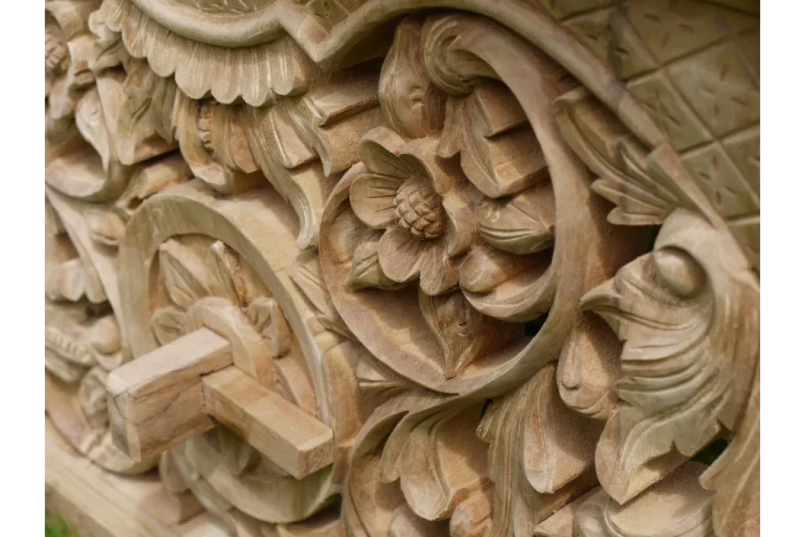 Hand-carved wooden furniture panel with intricate floral patterns and detailed craftsmanship
