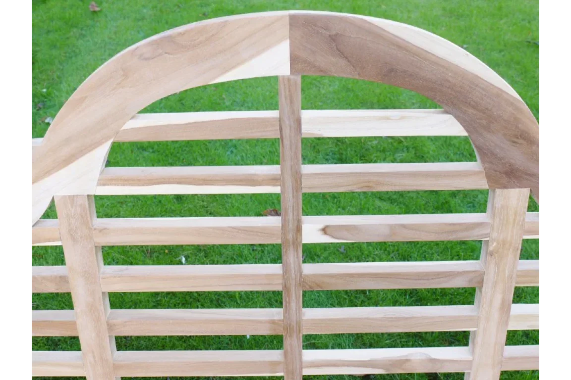 Slatted wooden garden bench backrest with natural finish on green lawn