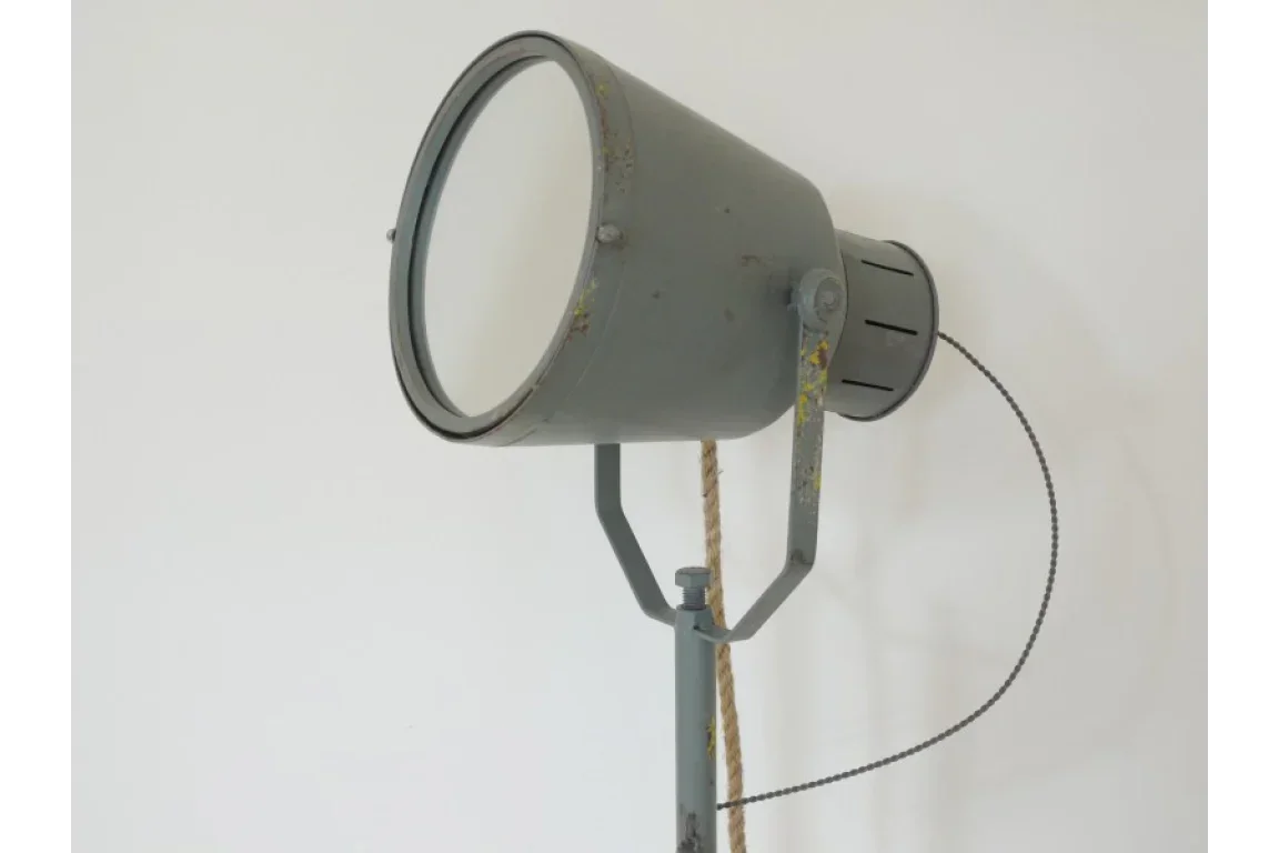 Industrial metal floor lamp with round shade and rope detail against white background
