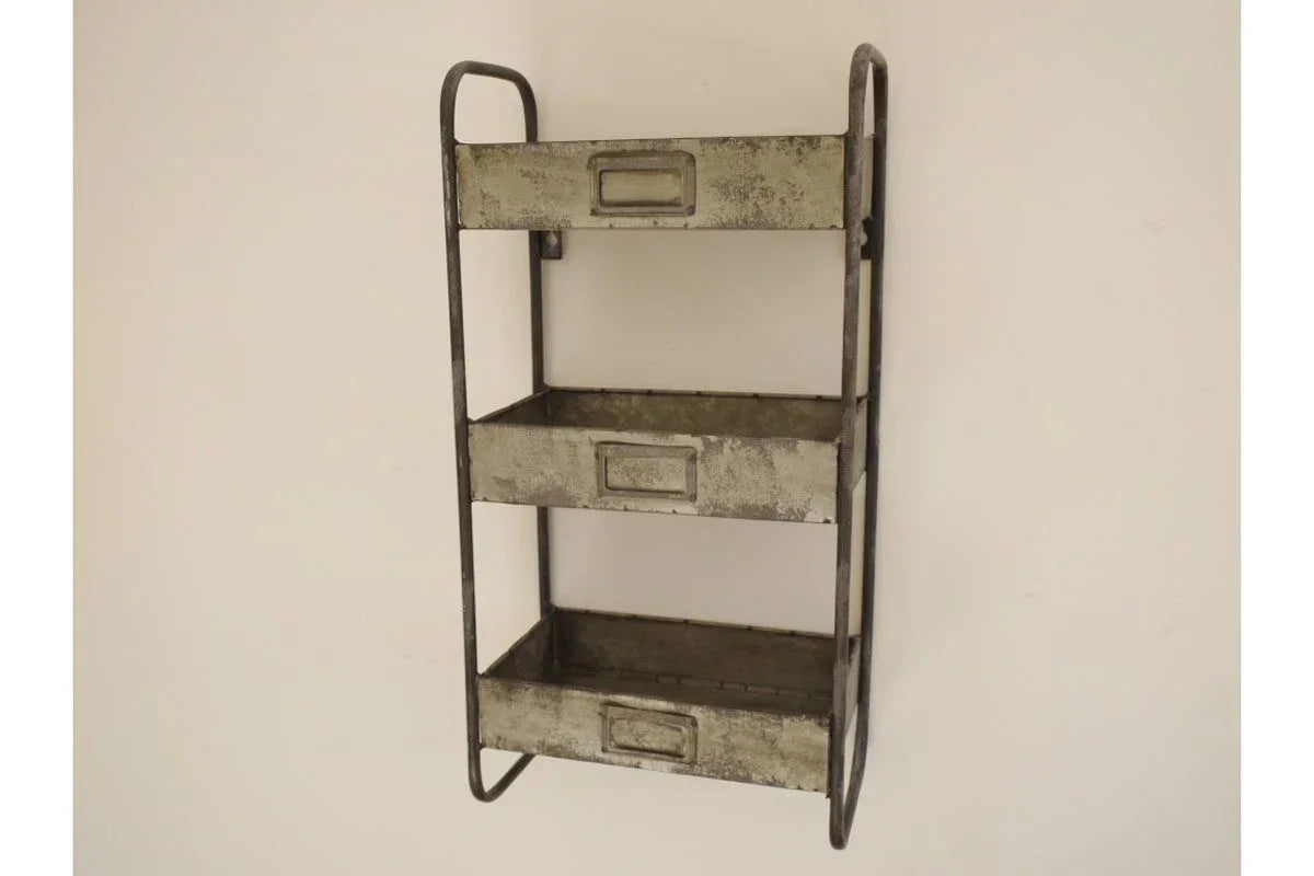 Three tier metal wall shelf with trays and handles mounted on white wall