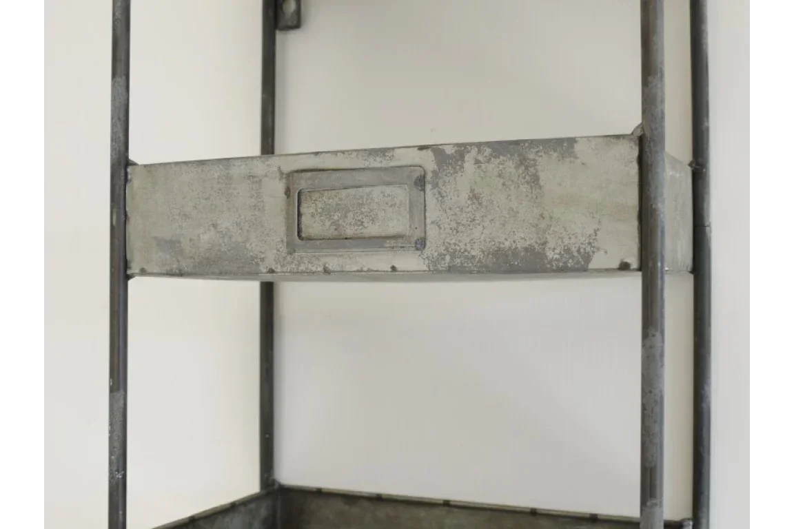 Industrial metal shelving unit with distressed finish and integrated storage drawer