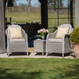 Grey rattan garden chairs with cushions and matching side table on patio