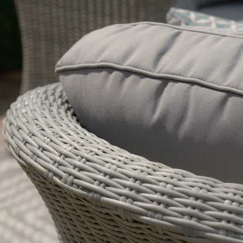 Close view of grey rattan garden chair with thick padded seat cushion