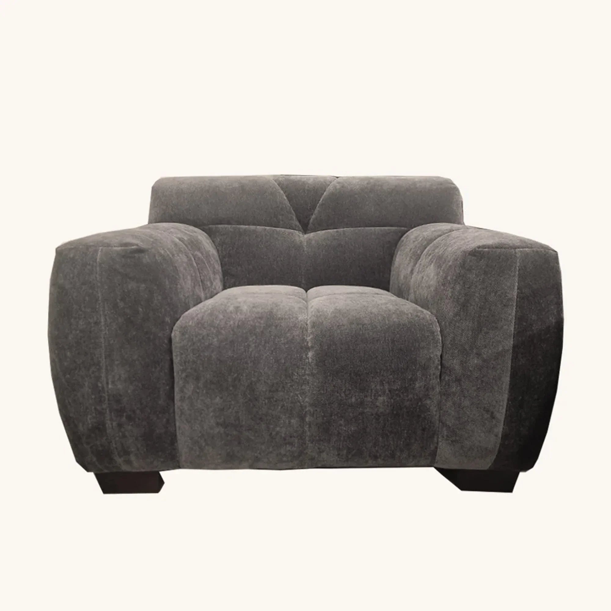Grey fabric armchair with wide padded arms and low wooden legs front view