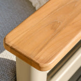 Oak wood armrest detail on fabric sofa with beige frame close up