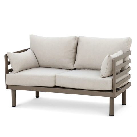 Beige outdoor sofa with metal frame and loose cushions, front view on white background