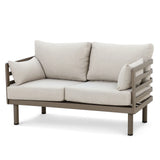 Beige outdoor sofa with metal frame and loose cushions, front view on white background