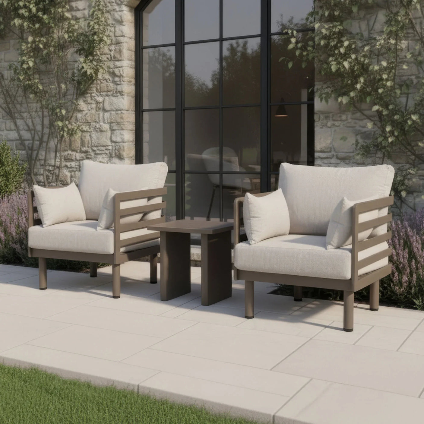Outdoor garden lounge chairs with beige cushions and side table on stone patio