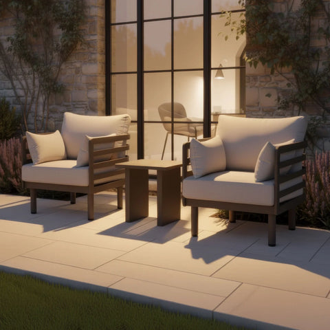 Outdoor armchair set with beige cushions and small coffee table on a paved patio