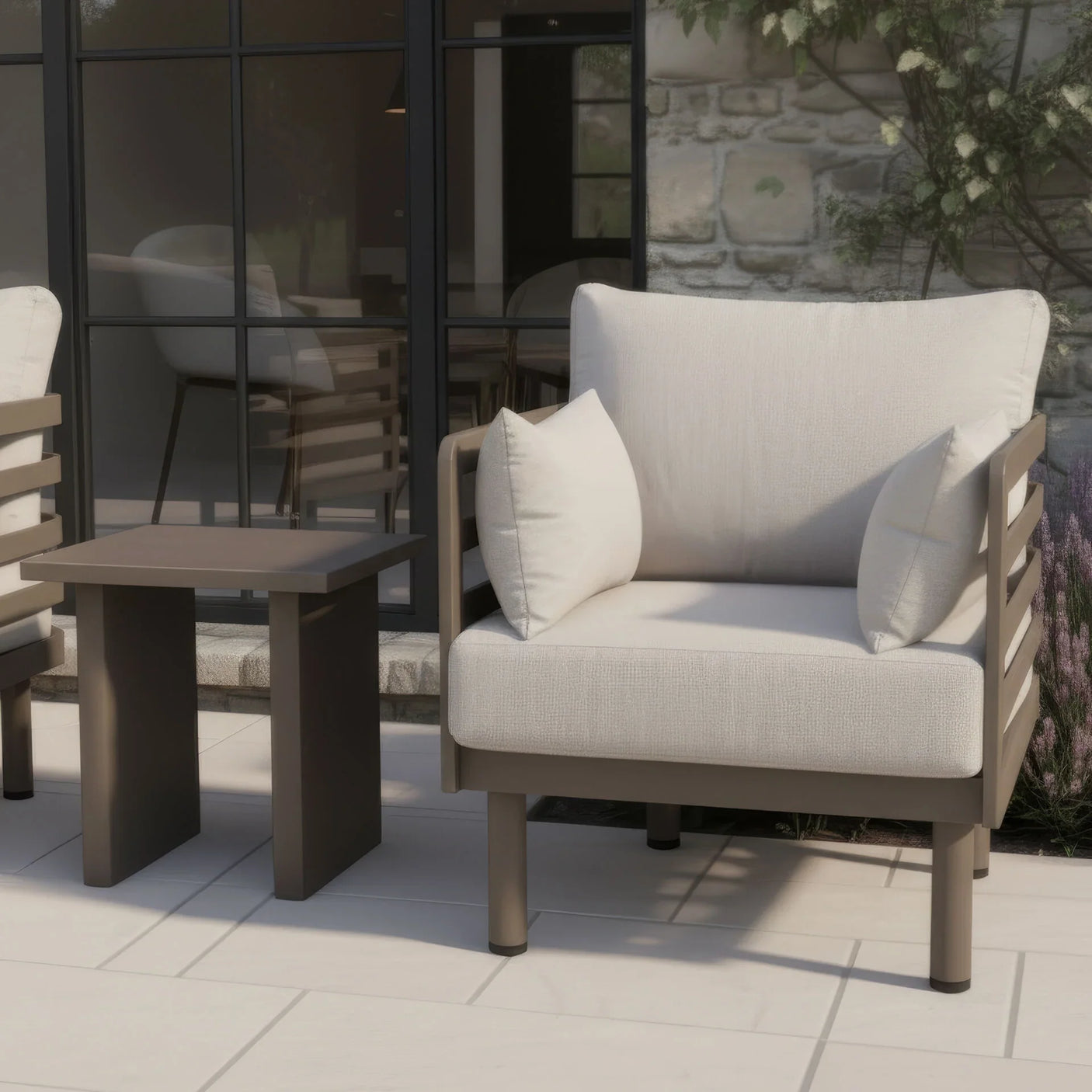 Outdoor armchair with beige cushions and matching side table on modern patio