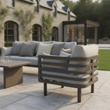 Outdoor garden lounge chair with grey cushions and metal frame on patio
