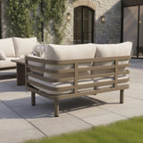 Outdoor garden sofa with beige cushions and metal frame on modern patio