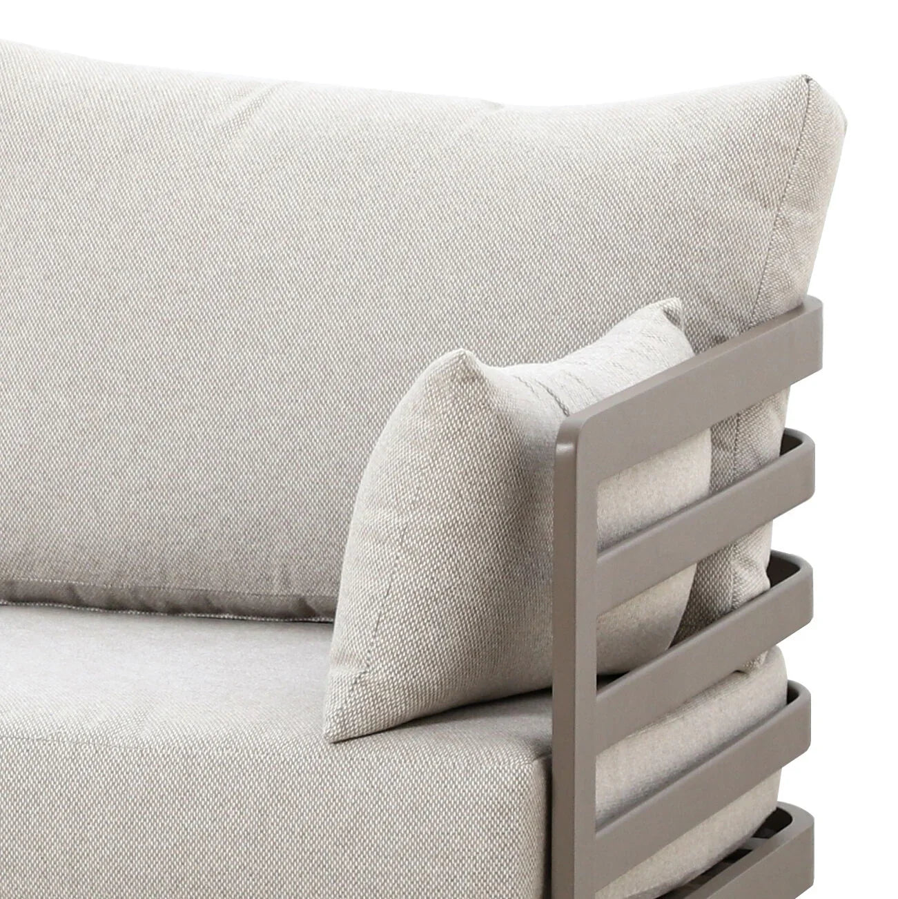 Closeup of beige fabric sofa corner with metal armrest and backrest cushions