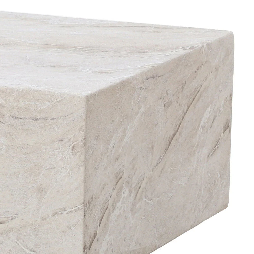 Closeup of stone effect coffee table with beige marbled finish and sharp edge detail