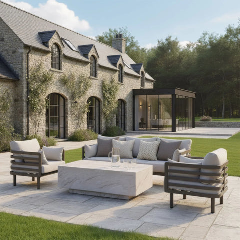 Modern outdoor sofa set with beige cushions and stone coffee table on patio
