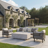Modern outdoor sofa set with beige cushions and stone coffee table on patio