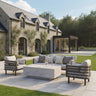 Modern outdoor sofa set with beige cushions and stone coffee table on patio