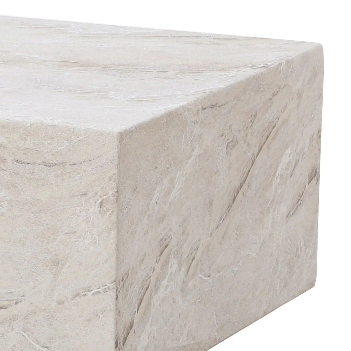 Beige stone effect coffee table with textured surface and sharp corner close-up