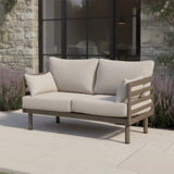 Outdoor garden sofa with beige cushions and wooden frame on patio