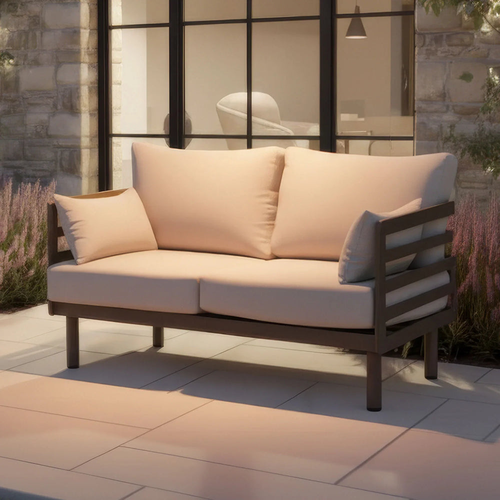 Outdoor garden sofa with beige cushions and modern wooden frame on patio