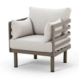 Modern beige fabric armchair with metal frame and three matching cushions, front angle view