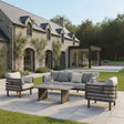 Modern outdoor garden sofa set with beige cushions and coffee table on stone patio