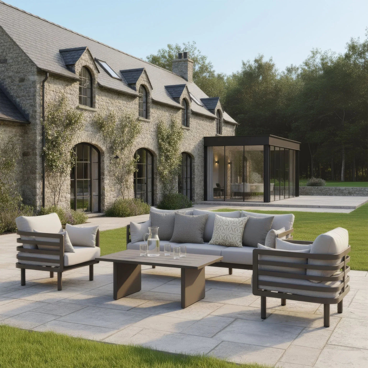 Modern outdoor garden sofa set with beige cushions and coffee table on stone patio