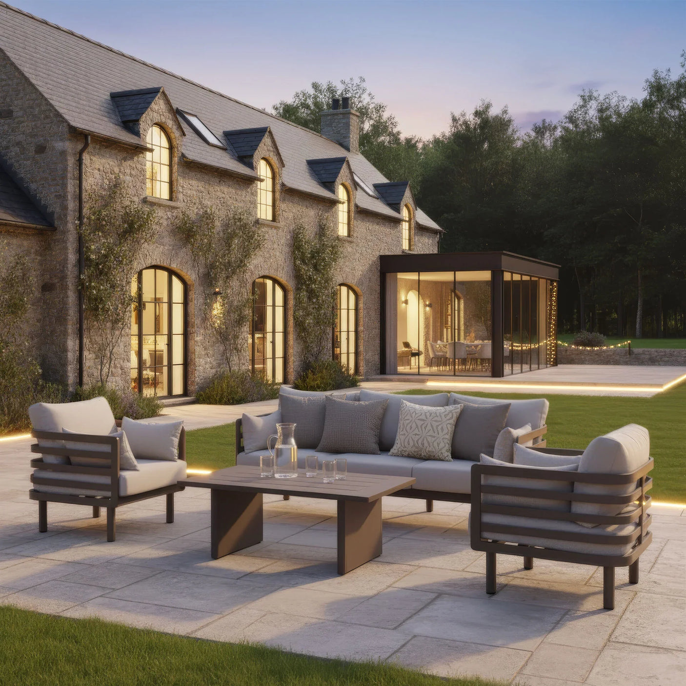 Grey outdoor garden furniture set with cushions on stone patio